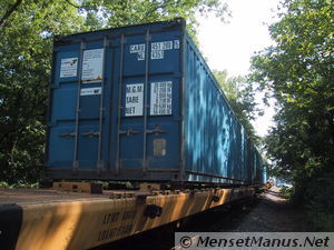 Shipping container on railcar
