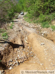 Creek, collapse in road
